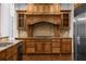 A gourmet kitchen features custom wood cabinetry, granite countertops, stainless steel appliances, and wood floors at 8805 Marion Dr, Duluth, GA 30097