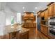 This spacious kitchen features granite countertops, custom cabinetry, stainless steel appliances, and hardwood floors at 8805 Marion Dr, Duluth, GA 30097