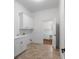 A bright laundry room features built-in cabinetry and counter space, complemented by neutral tile flooring at 8805 Marion Dr, Duluth, GA 30097