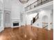 A bright living room with a fireplace, built-in shelves, and stairs to the second floor at 8805 Marion Dr, Duluth, GA 30097