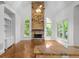 Spacious living room with a stone fireplace, large windows, and hardwood floors at 8805 Marion Dr, Duluth, GA 30097