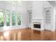 Living room featuring a fireplace, built-in shelving, and large windows at 8805 Marion Dr, Duluth, GA 30097