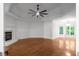 Spacious living room with hardwood floors, a fireplace, and multiple windows at 8805 Marion Dr, Duluth, GA 30097