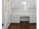 Bright office space with white cabinets and drawers lining the wall under a window and dark hardwood floors at 8805 Marion Dr, Duluth, GA 30097