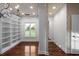 Luxury walk-in closet with custom shelving, chandelier, and a view to the yard at 8805 Marion Dr, Duluth, GA 30097