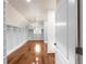 Spacious walk-in closet with custom shelving, hardwood floors, and a stylish chandelier at 8805 Marion Dr, Duluth, GA 30097