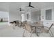 Covered patio featuring ceiling fans, neutral-toned outdoor furniture, brick detailing and stylish decor for relaxation at 3348 Cranston Ln, Kennesaw, GA 30144