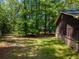 View of the back of the house and the backyard on this wooded lot at 5216 Wheeler Dr, Loganville, GA 30052