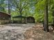 View of the car port and a matching shed, nestled among mature trees, adding extra outdoor storage at 5216 Wheeler Dr, Loganville, GA 30052