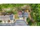 An overhead aerial view of this townhome shows a home with easy access to a long driveway and a green, wooded backyard at 5989 Turfway Park Ct, Sugar Hill, GA 30518