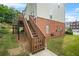 Back exterior of home showcasing a wooden deck and yard at 5989 Turfway Park Ct, Sugar Hill, GA 30518