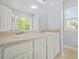 Bright bathroom with dual sinks, vanity, and a window allowing for natural light at 5989 Turfway Park Ct, Sugar Hill, GA 30518