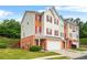 Attractive townhouse with two-car garage, neutral siding, brick accents and a lush, well-manicured lawn at 5989 Turfway Park Ct, Sugar Hill, GA 30518