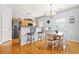 Eat-in kitchen with a stainless steel refrigerator, granite countertops, and hardwood flooring at 5989 Turfway Park Ct, Sugar Hill, GA 30518