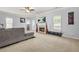 Spacious living room with fireplace, ceiling fan, lots of light and plush furniture at 5989 Turfway Park Ct, Sugar Hill, GA 30518