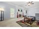 Cozy living room with fireplace, tv, ceiling fan, and plush furniture at 5989 Turfway Park Ct, Sugar Hill, GA 30518