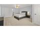 Well-lit bedroom with neutral walls, carpet, ceiling fan, and a gray upholstered bed frame at 5989 Turfway Park Ct, Sugar Hill, GA 30518