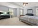 Spacious main bedroom with large windows, sitting area, tray ceiling, and tv at 5989 Turfway Park Ct, Sugar Hill, GA 30518