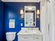 Stylish bathroom with blue accent wall, marble countertop vanity, and modern lighting at 735 Longwood Nw Dr, Atlanta, GA 30305