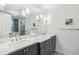 Bright bathroom featuring a double vanity with marble countertops and modern lighting fixtures at 735 Longwood Nw Dr, Atlanta, GA 30305