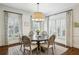 Cozy dining area with a large table, chairs, and lots of natural light from the many windows at 735 Longwood Nw Dr, Atlanta, GA 30305