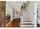 Elegant foyer featuring hardwood floors, staircase, chandelier, and views into the kitchen and living areas at 735 Longwood Nw Dr, Atlanta, GA 30305