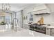 Modern kitchen featuring quartz countertops, stainless steel appliances, and designer fixtures at 735 Longwood Nw Dr, Atlanta, GA 30305