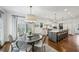 Open-concept kitchen flowing into the breakfast nook featuring island, white cabinetry, and hardwood floors at 735 Longwood Nw Dr, Atlanta, GA 30305