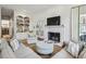 Inviting living room with fireplace, built-in bookshelves, and a comfortable seating area with a large TV at 735 Longwood Nw Dr, Atlanta, GA 30305