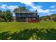 Expansive backyard view showing a large lawn, a deck, and the home's rear elevation at 2505 Tiffany Se Ct, Conyers, GA 30013