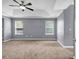 Spacious bedroom with soft carpet, neutral walls and natural light from windows at 2505 Tiffany Se Ct, Conyers, GA 30013