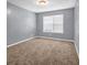 This bedroom features plush carpet and natural light at 2505 Tiffany Se Ct, Conyers, GA 30013