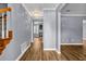 Hallway featuring hardwood floors, neutral gray walls, and a staircase with wooden banisters at 2505 Tiffany Se Ct, Conyers, GA 30013