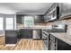 Modern kitchen showcasing stainless steel appliances, dark cabinetry, and granite countertops at 2505 Tiffany Se Ct, Conyers, GA 30013