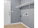Laundry room showing tile floor, access door, shelving and connections at 2505 Tiffany Se Ct, Conyers, GA 30013
