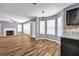 Open-concept living room with fireplace, hardwood floors, and tons of natural light at 2505 Tiffany Se Ct, Conyers, GA 30013
