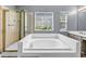 Relax in the soaking tub, or enjoy the glass shower in this well-lit main bathroom at 2505 Tiffany Se Ct, Conyers, GA 30013