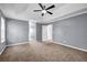 This main bedroom features plush carpet, a ceiling fan, natural light, and ample space at 2505 Tiffany Se Ct, Conyers, GA 30013