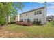 Expansive backyard featuring a well-maintained lawn, wooden deck, and the home's exterior at 3925 Tugaloo River Dr, Duluth, GA 30097