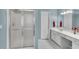 Bathroom features a vanity with double sinks and a glass shower at 3925 Tugaloo River Dr, Duluth, GA 30097