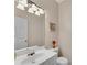 Well-lit half bath with a white sink and chrome fixtures at 3925 Tugaloo River Dr, Duluth, GA 30097