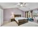 Comfortable bedroom with soft lighting, a ceiling fan, and window views at 3925 Tugaloo River Dr, Duluth, GA 30097