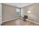 Bedroom featuring hard wood floors, a single window, and a reading chair at 3925 Tugaloo River Dr, Duluth, GA 30097