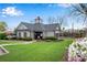 Community clubhouse featuring well-manicured lawn, flowering plants, and community pool at 3925 Tugaloo River Dr, Duluth, GA 30097