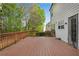 View of spacious wooden deck, perfect for outdoor relaxation and entertaining, adjacent to lush greenery at 3925 Tugaloo River Dr, Duluth, GA 30097