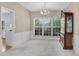 Cozy dining room featuring a chandelier, large window, and classic wood furniture at 3925 Tugaloo River Dr, Duluth, GA 30097