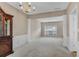 Open dining room with natural light, wainscoting, and view into living spaces at 3925 Tugaloo River Dr, Duluth, GA 30097