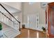 Bright foyer with hardwood floors, a staircase, and natural light from sidelight windows at 3925 Tugaloo River Dr, Duluth, GA 30097