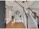 Spacious foyer with hardwood floors, staircase, and a view into the dining and living areas at 3925 Tugaloo River Dr, Duluth, GA 30097