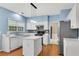 Charming kitchen with white cabinets, island, and modern lighting at 3925 Tugaloo River Dr, Duluth, GA 30097